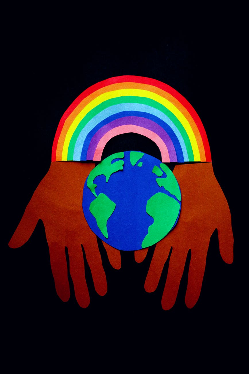 picture of rainbow over the earth and hands that show respect for it and all things within that define your personal values